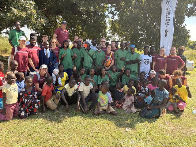 Ugandan dental students, visiting clinicians and children after an outreach day