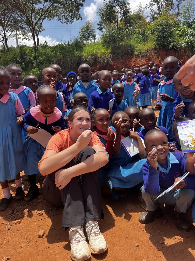 A volunteer with schoolchildren
